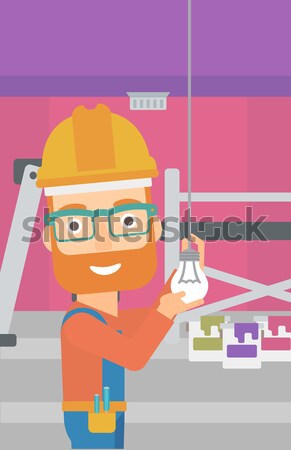 Electrician twisting light bulb. Stock photo © RAStudio