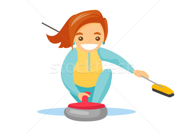 Stock photo: Caucasian sportswoman playing curling on ice rink.