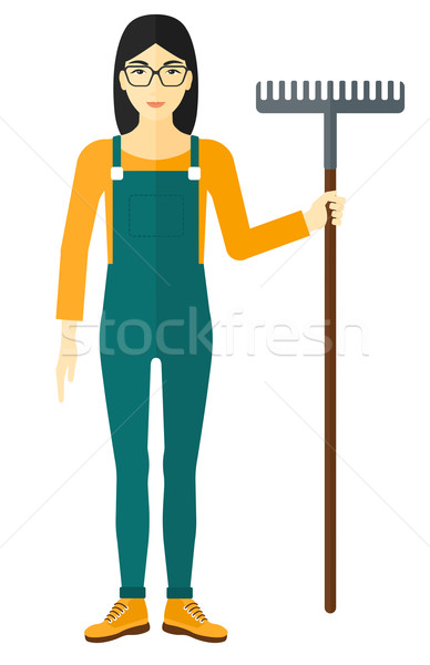 Stock photo: Farmer with rake.