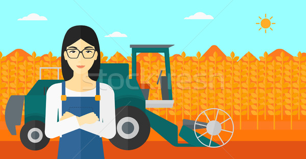 Woman standing with combine on background. Stock photo © RAStudio