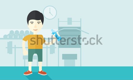Gentleman drink a bottle of water while inside the gym. Stock photo © RAStudio