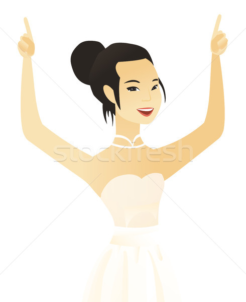 Young asian fiancee standing with raised arms up. Stock photo © RAStudio