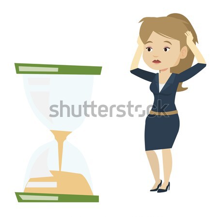 Desperate business woman looking at hourglass. Stock photo © RAStudio