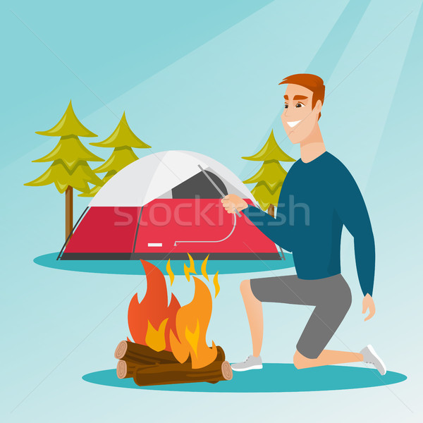 Young caucasian white man making the campfire. Stock photo © RAStudio