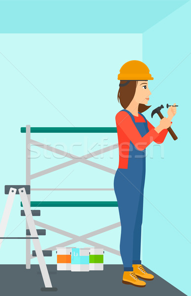 Constructor hammering nail. Stock photo © RAStudio