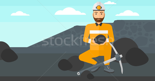 Miner holding coal in hands. Stock photo © RAStudio