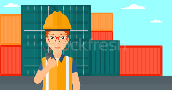 Stevedore standing on cargo containers background. Stock photo © RAStudio