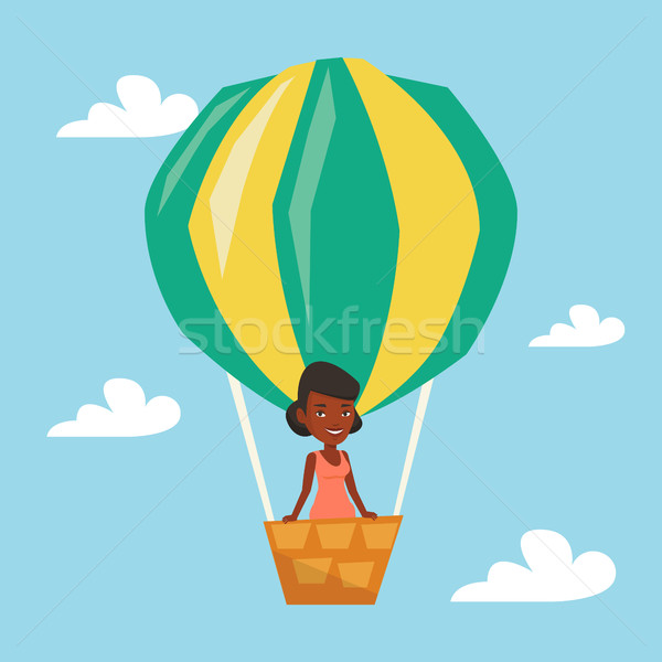 Mulher voador balão de ar quente africano em pé cesta Foto stock © RAStudio