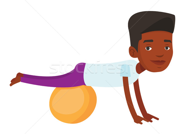 Young man exercising with fitball. Stock photo © RAStudio