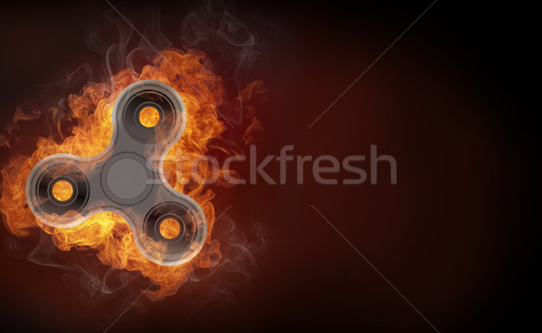Fidget spinner in fire isolated on black background banner. Stock photo © RAStudio