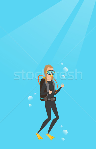 Young caucasian scuba diver giving thumb up. Stock photo © RAStudio