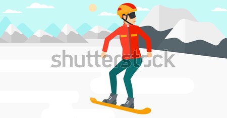 Stock photo: Young woman snowboarding.