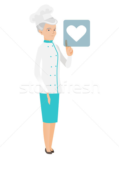 Caucasian chef cook pressing web button with heart Stock photo © RAStudio