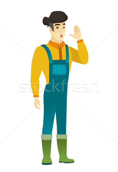 Stock photo: Asian farmer calling for help.