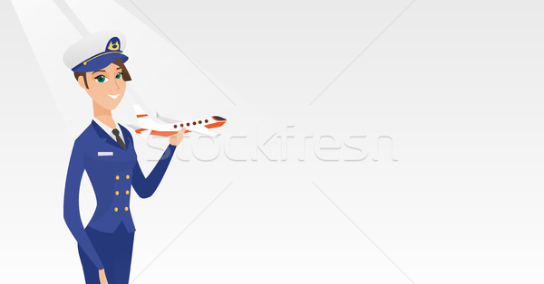 Cheerful airline pilot with the model of airplane. Stock photo © RAStudio