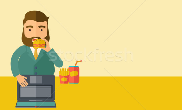 Young fat guy eating while at work. Stock photo © RAStudio