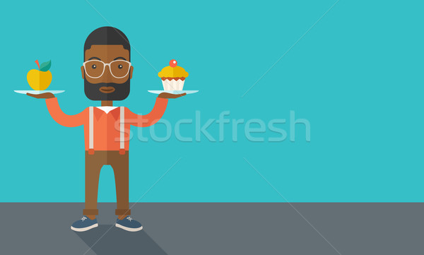 Stock photo: Man carries with his two hands cupcake and apple.