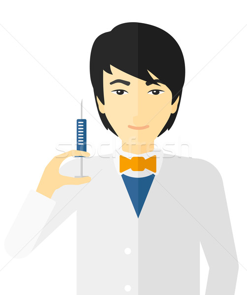 Doctor holding syringe. Stock photo © RAStudio