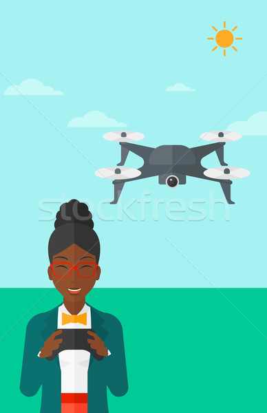 Stock photo: Woman flying drone.