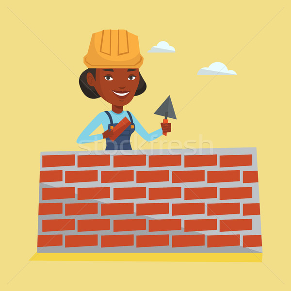 Bricklayer working with spatula and brick. Stock photo © RAStudio
