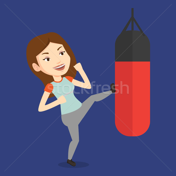 Woman exercising with punching bag. Stock photo © RAStudio