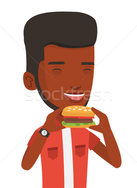 Stock fotó: Férfi · eszik · hamburger · boldog · csukott · szemmel · harap