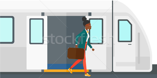 Stock photo: Woman going out of train.