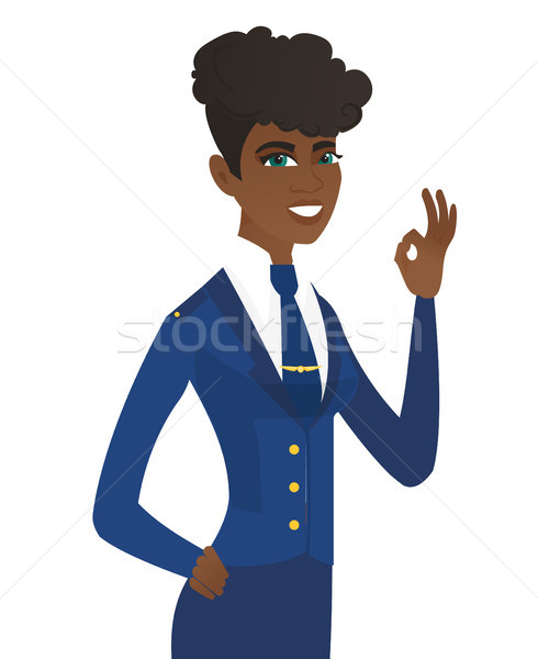 Young african-american stewardess showing ok sign. Stock photo © RAStudio