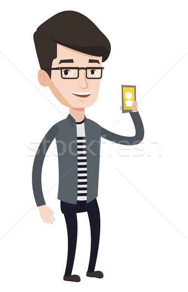 Man holding ringing mobile phone. Stock photo © RAStudio