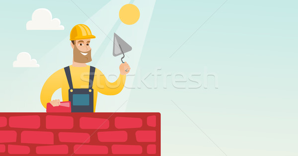 Bricklayer working with spatula and brick. Stock photo © RAStudio
