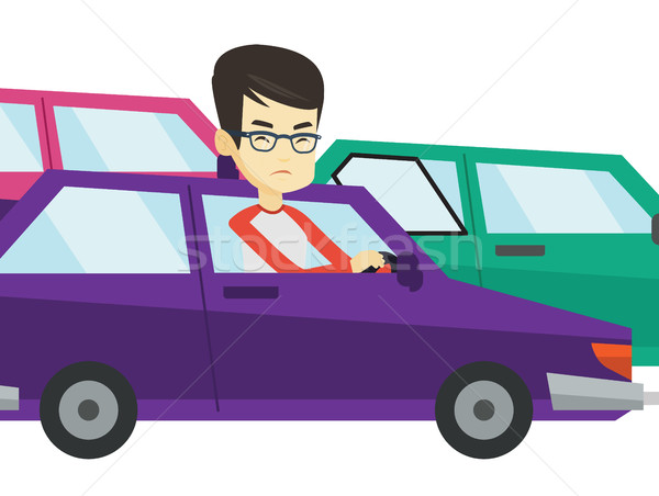 Stock photo: Angry asian man in car stuck in traffic jam.