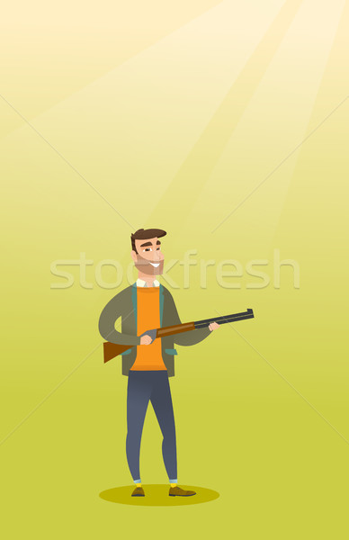 Young caucasian hunter holding a hunting rifle. Stock photo © RAStudio