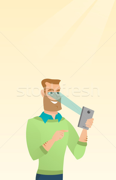 Stock photo: Man using iris scanner to unlock his mobile phone.