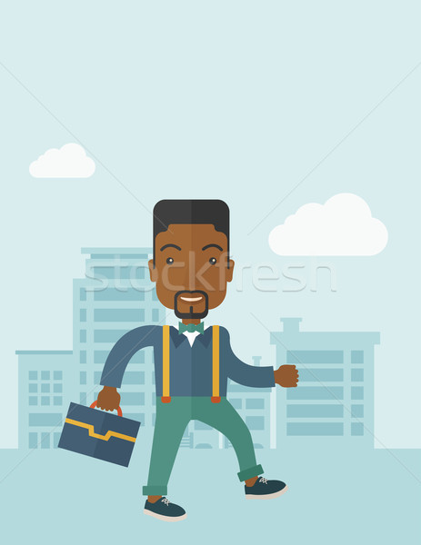 Young man walking through the city's street with his briefcase. Stock photo © RAStudio
