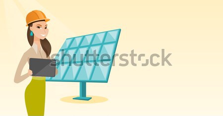 Female worker of solar power plant. Stock photo © RAStudio