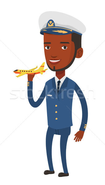 Cheerful airline pilot with model of airplane. Stock photo © RAStudio