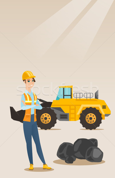 Miner with a big excavator on background. Stock photo © RAStudio