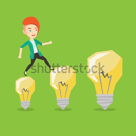 Business woman jumping on light bulbs. Stock photo © RAStudio