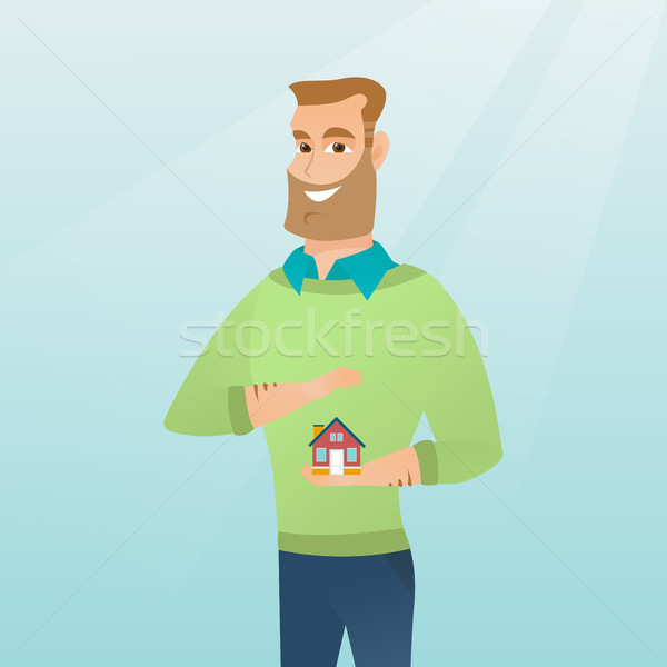 Insurance agent protecting model of house. Stock photo © RAStudio