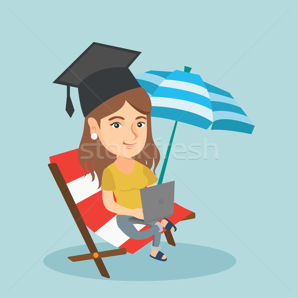 Graduate lying in chaise lounge with a laptop. Stock photo © RAStudio