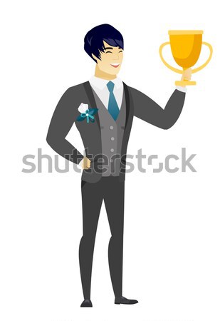 Young caucasian groom holding a trophy. Stock photo © RAStudio