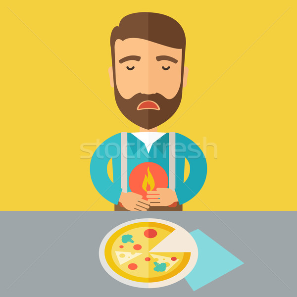 Man has a stomach burn or abdominal pain after he ate pizza. Stock photo © RAStudio