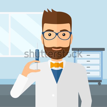 Doctor holding syringe. Stock photo © RAStudio