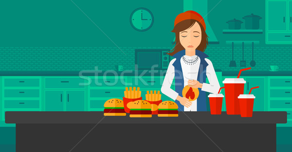 Kobieta cierpienie zgaga stałego stół kuchenny pełny Zdjęcia stock © RAStudio