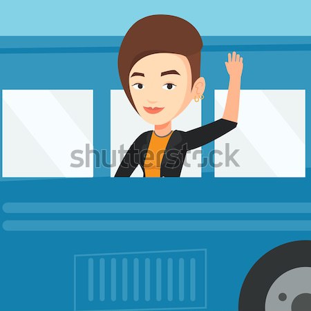 Woman waving hand from bus window. Stock photo © RAStudio