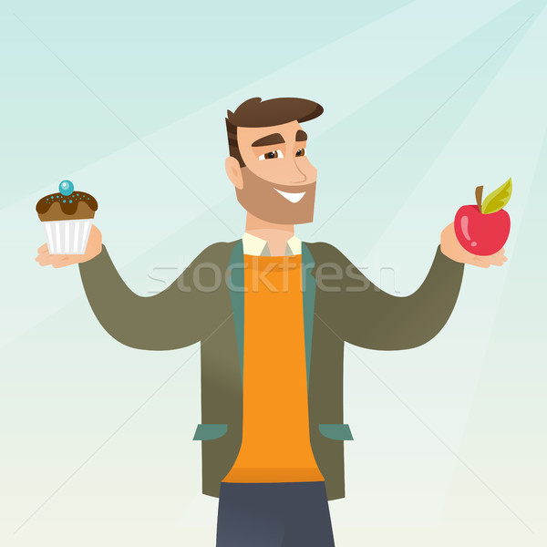 Man choosing between an apple and a cupcake. Stock photo © RAStudio
