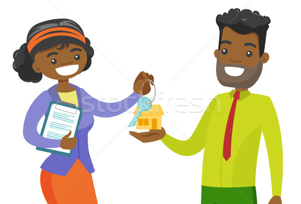 Real estate agent giving house key to a client. Stock photo © RAStudio