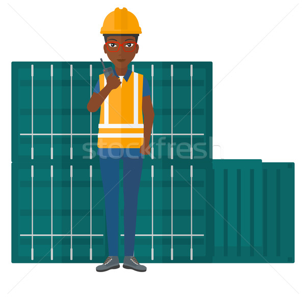 Stevedore standing on cargo containers background. Stock photo © RAStudio