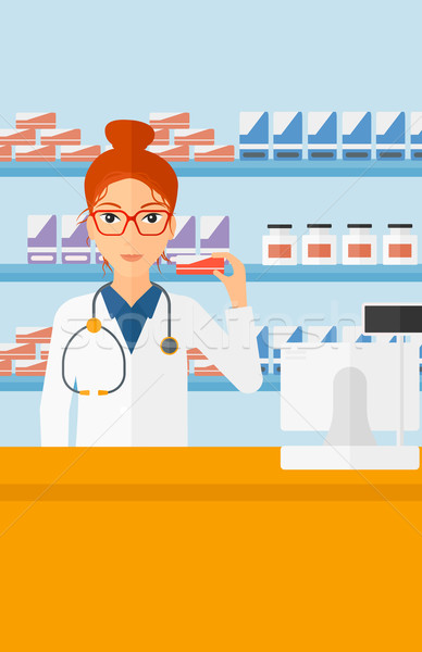 Pharmacist showing some medicine. Stock photo © RAStudio