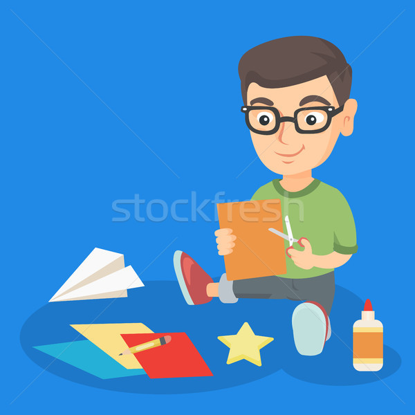 Little boy crafting with scissors and color paper. Stock photo © RAStudio